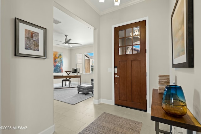 entrance foyer with ornamental molding, ceiling fan, and light tile patterned flooring