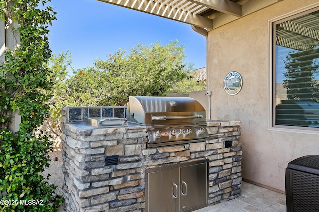 view of patio featuring grilling area and exterior kitchen