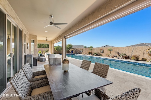 view of patio with ceiling fan and a fenced in pool