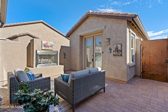 view of patio with an outdoor fireplace