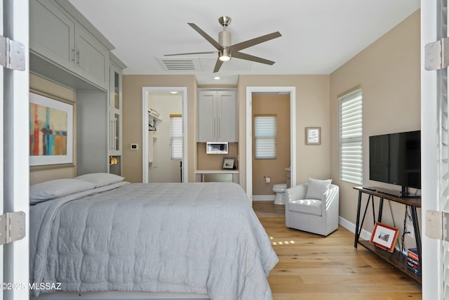 bedroom featuring ensuite bathroom, ceiling fan, and light hardwood / wood-style flooring