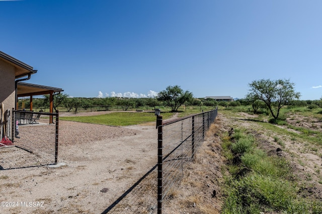 view of yard with a rural view