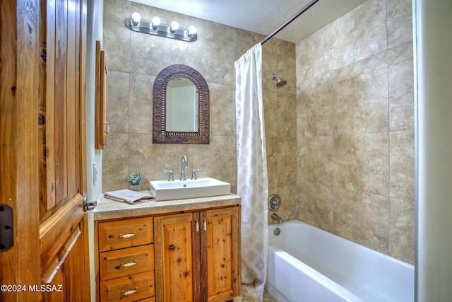 bathroom with vanity, tile walls, and shower / bath combo