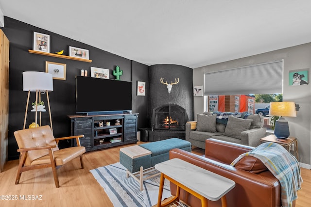 living room with hardwood / wood-style floors and a large fireplace