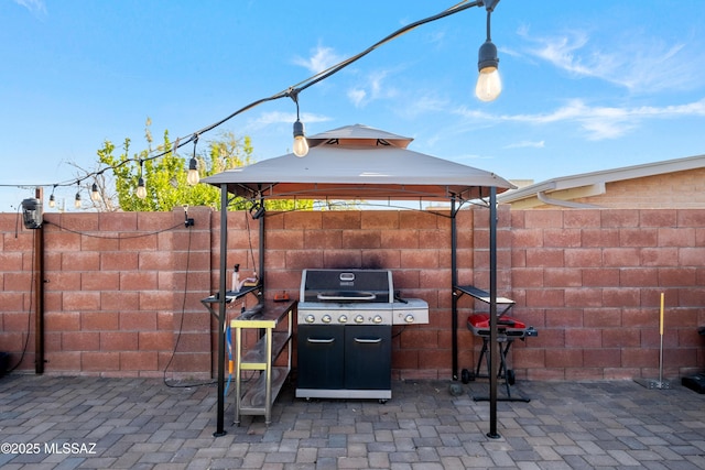 view of patio / terrace featuring a gazebo and a grill