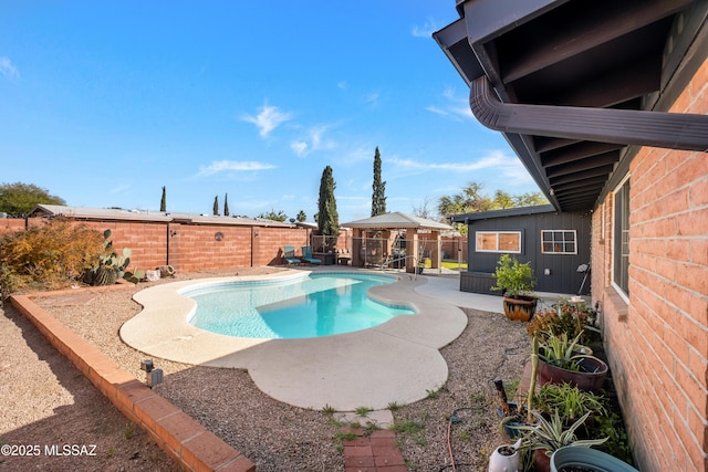 view of swimming pool with a gazebo and a patio area