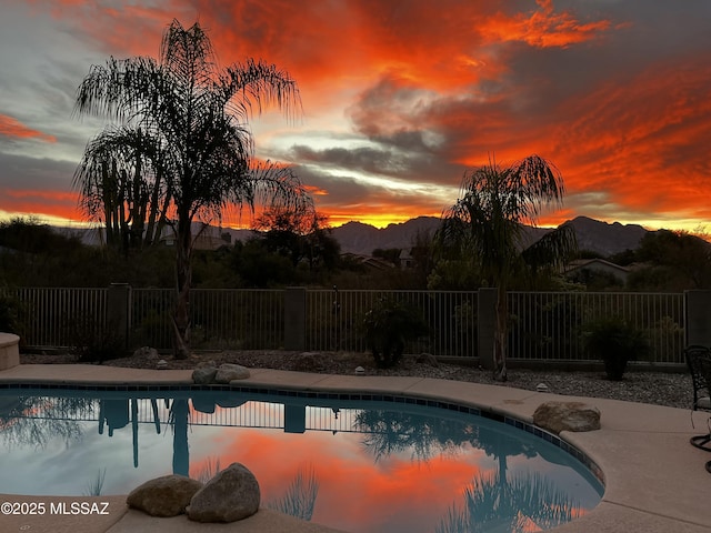 pool at dusk with a mountain view