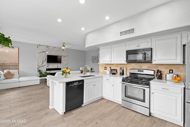 kitchen featuring black appliances, sink, white cabinets, ceiling fan, and kitchen peninsula