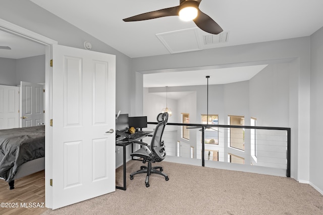 carpeted office featuring vaulted ceiling and ceiling fan