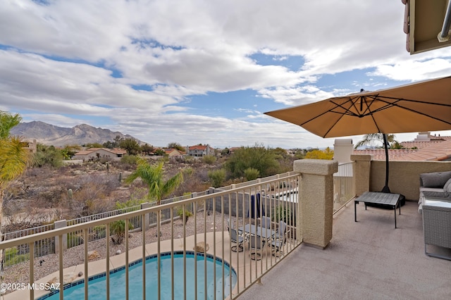 balcony featuring a mountain view and a patio