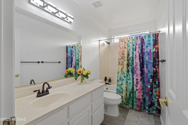 full bathroom featuring vanity, shower / bath combination with curtain, and toilet