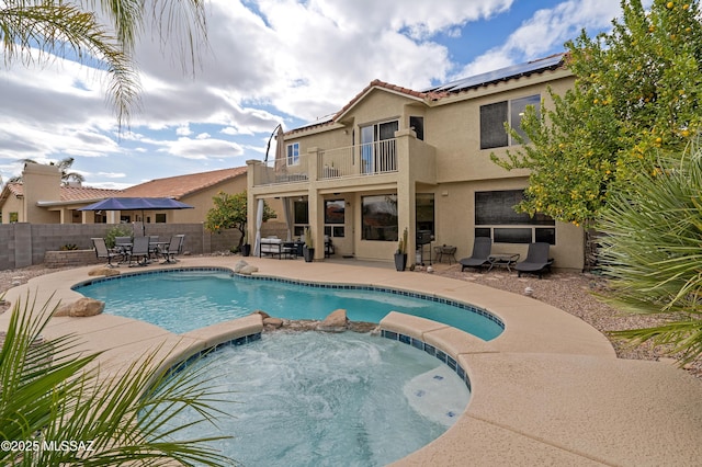 view of pool featuring an in ground hot tub and a patio