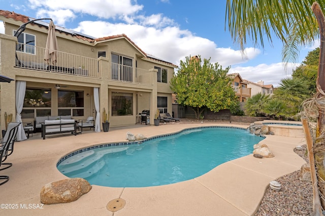 view of pool featuring an in ground hot tub, an outdoor living space, and a patio