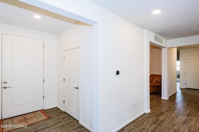 hall with dark wood-type flooring