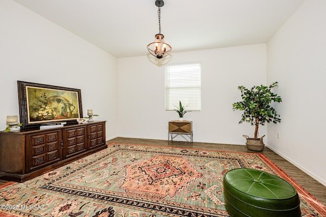 living area featuring an inviting chandelier and hardwood / wood-style flooring