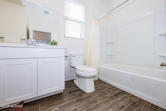 full bathroom featuring hardwood / wood-style flooring, vanity, toilet, and shower / bath combination with curtain