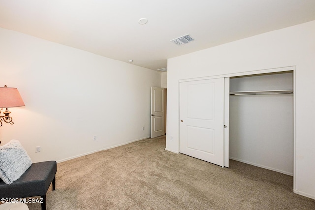 bedroom with light carpet and a closet