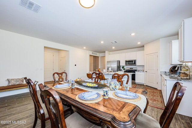 dining room with dark hardwood / wood-style flooring