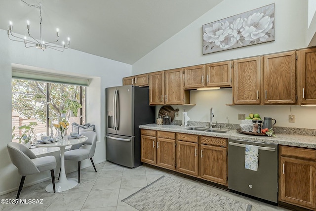 kitchen with a chandelier, appliances with stainless steel finishes, brown cabinetry, and a sink