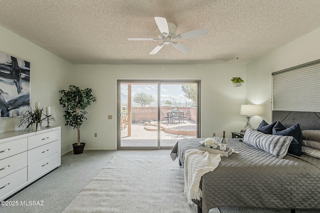 bedroom with a textured ceiling, access to exterior, a ceiling fan, and light carpet