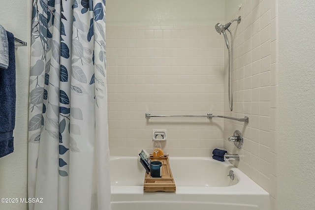 full bathroom featuring shower / bath combo with shower curtain and a textured wall