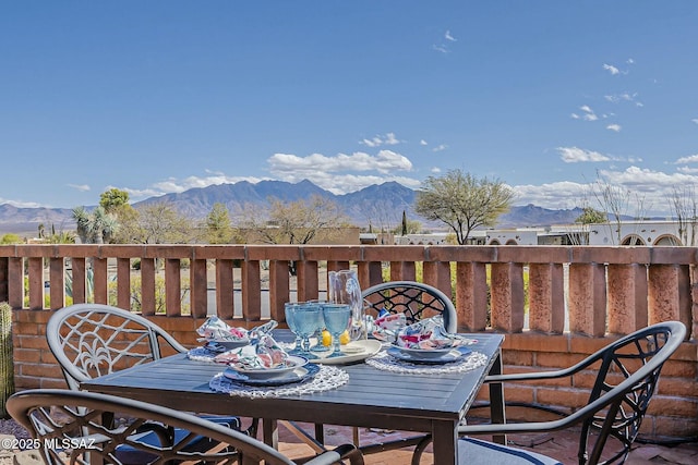 deck featuring outdoor dining space and a mountain view