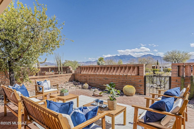 view of patio / terrace with a mountain view, an outdoor hangout area, and a fenced backyard