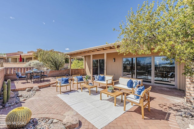 view of patio / terrace featuring outdoor dining space, outdoor lounge area, and fence