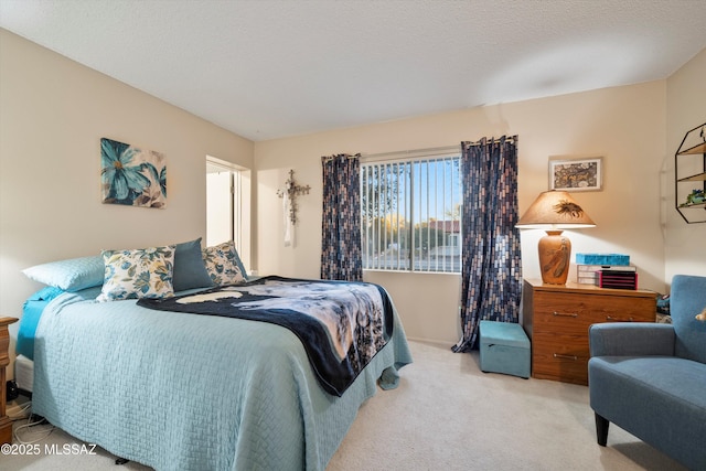 bedroom featuring light colored carpet and a textured ceiling