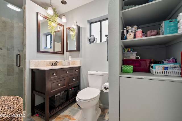 bathroom featuring an enclosed shower, vanity, and toilet