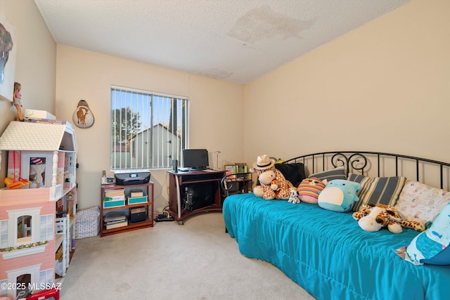 bedroom featuring carpet floors and a textured ceiling