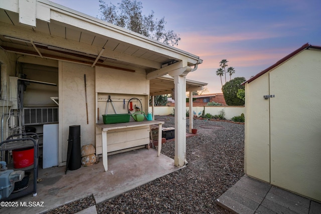 view of patio terrace at dusk