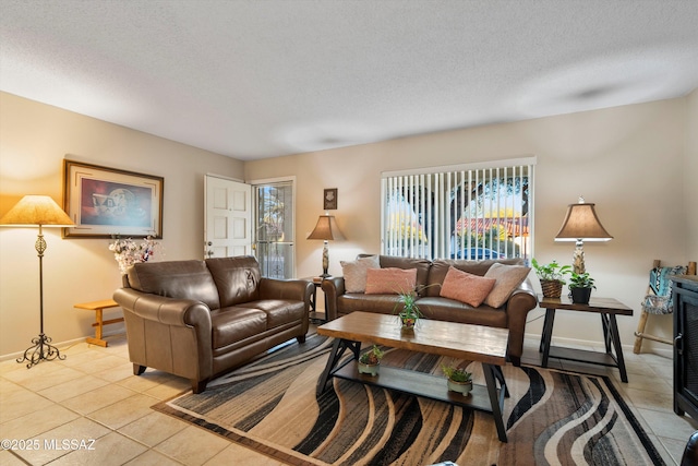 living room with light tile patterned floors and a textured ceiling