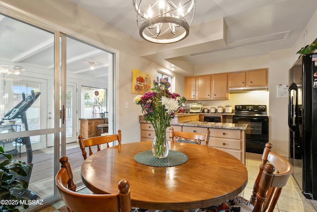 dining space featuring light tile patterned floors and a chandelier