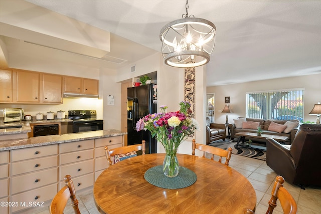 tiled dining area with a chandelier