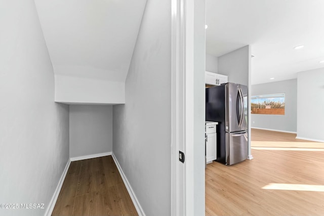 interior space featuring recessed lighting, baseboards, and light wood finished floors
