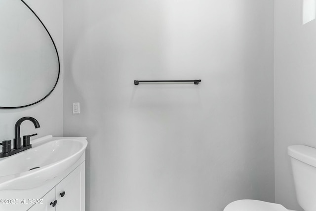 bathroom featuring toilet and vanity
