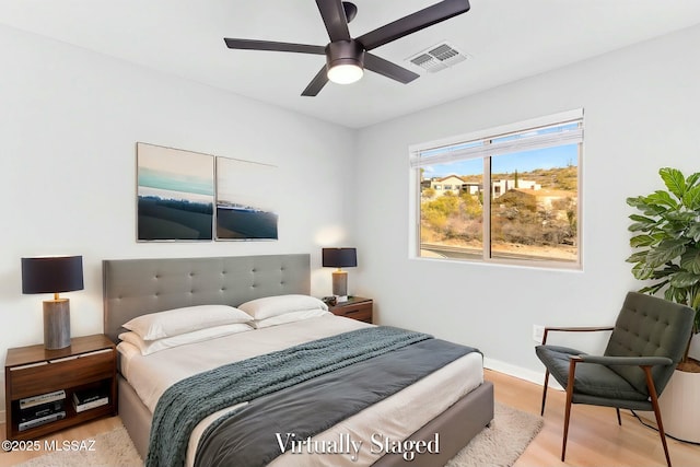 bedroom with visible vents, ceiling fan, light wood-style flooring, and baseboards