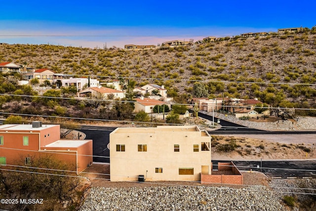 aerial view at dusk featuring a residential view
