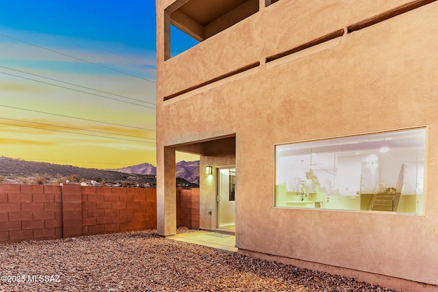 exterior space featuring fence and stucco siding