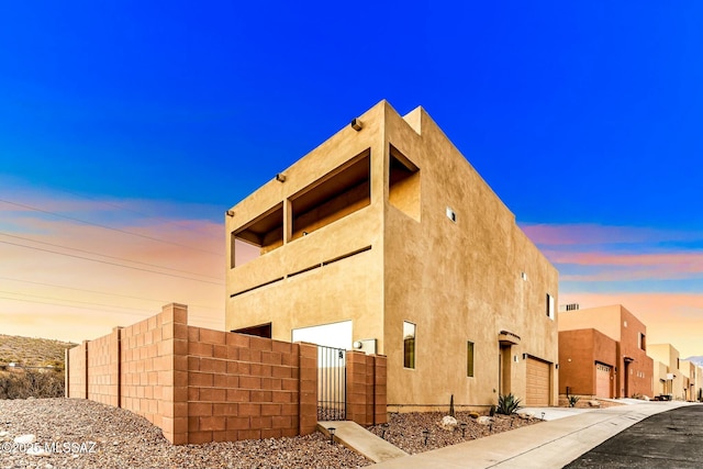 view of property featuring a garage and fence