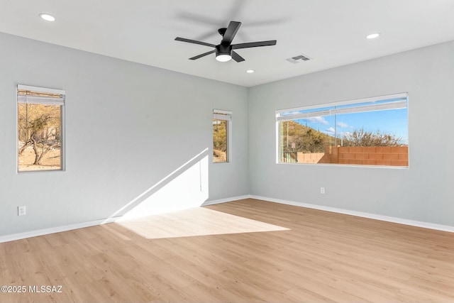 spare room with recessed lighting, baseboards, and light wood finished floors