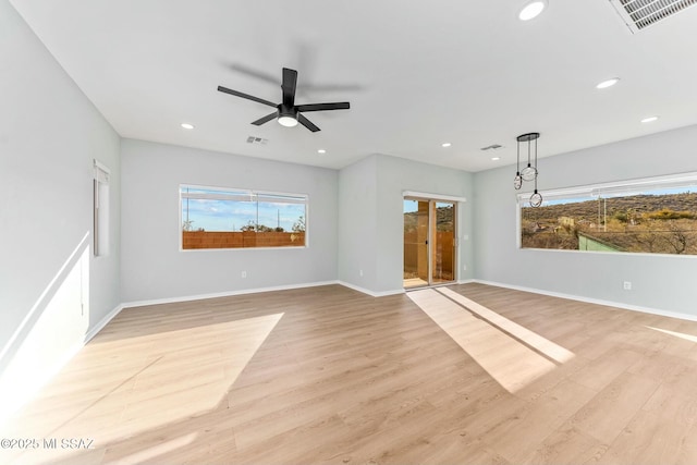 unfurnished living room featuring light wood-type flooring, baseboards, visible vents, and recessed lighting