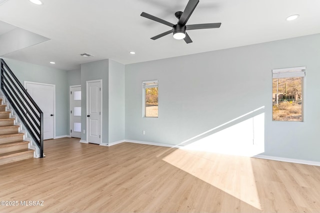 interior space featuring light wood-style floors, stairs, baseboards, and recessed lighting