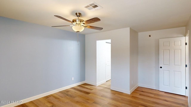 empty room featuring light hardwood / wood-style flooring and ceiling fan