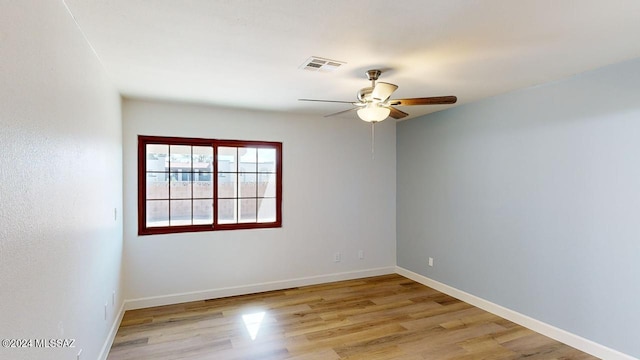 empty room featuring ceiling fan and light hardwood / wood-style flooring