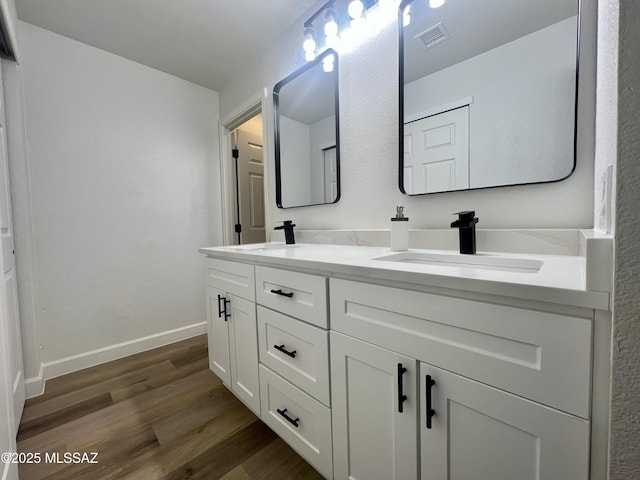 bathroom featuring vanity and hardwood / wood-style floors