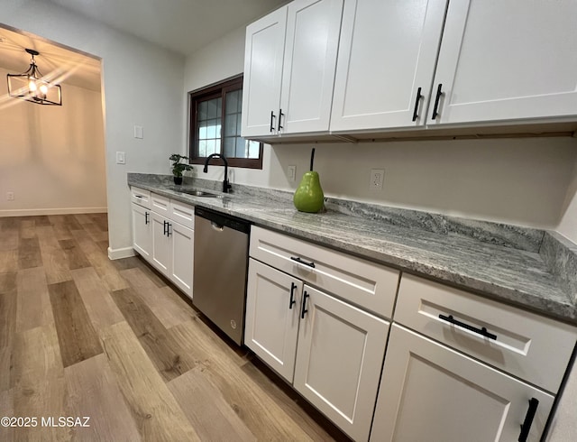 kitchen with dishwasher, sink, and white cabinets