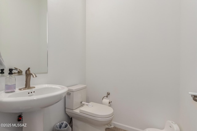 bathroom featuring sink and toilet