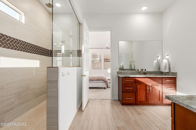 bathroom featuring vanity and tiled shower